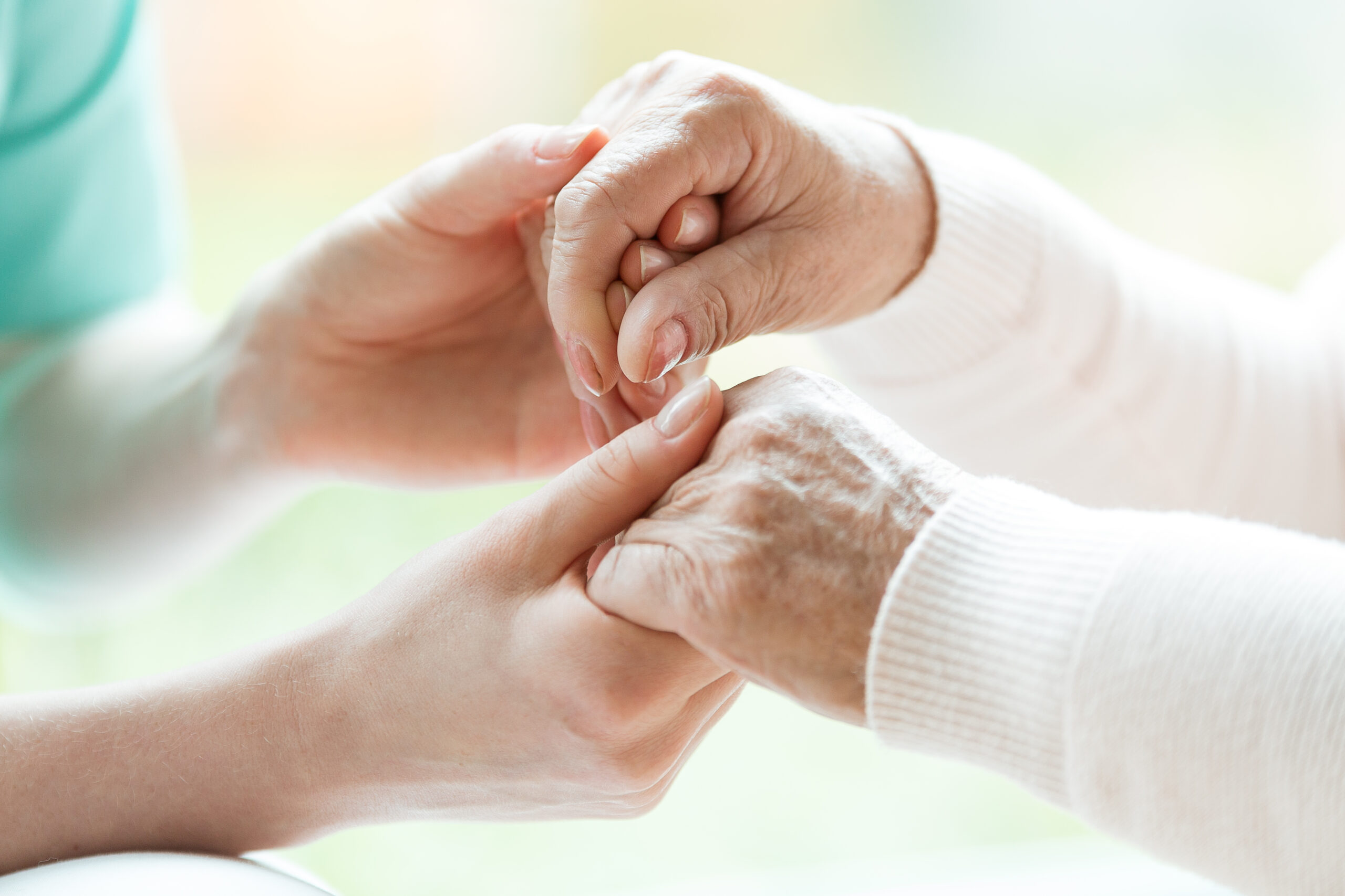 Close-up of holding hands - NursLink